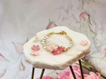 High-lustre Keshi pearls with gold-plated beads and micro crochet Sakura blossoms. 18K gold-plated jewelry wire, beads and chain clasp.