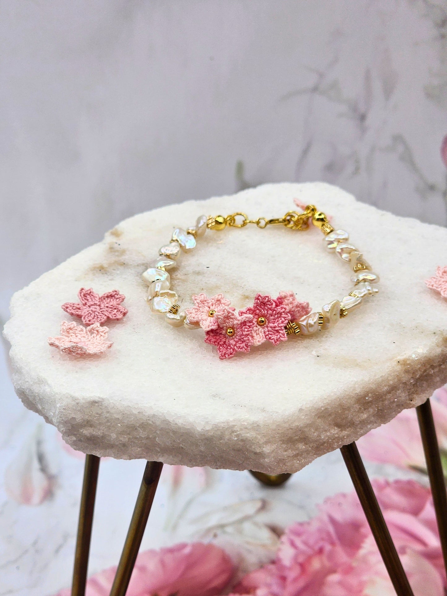 High-lustre Keshi pearls with gold-plated beads and micro crochet Sakura blossoms. 18K gold-plated jewelry wire, beads and chain clasp.