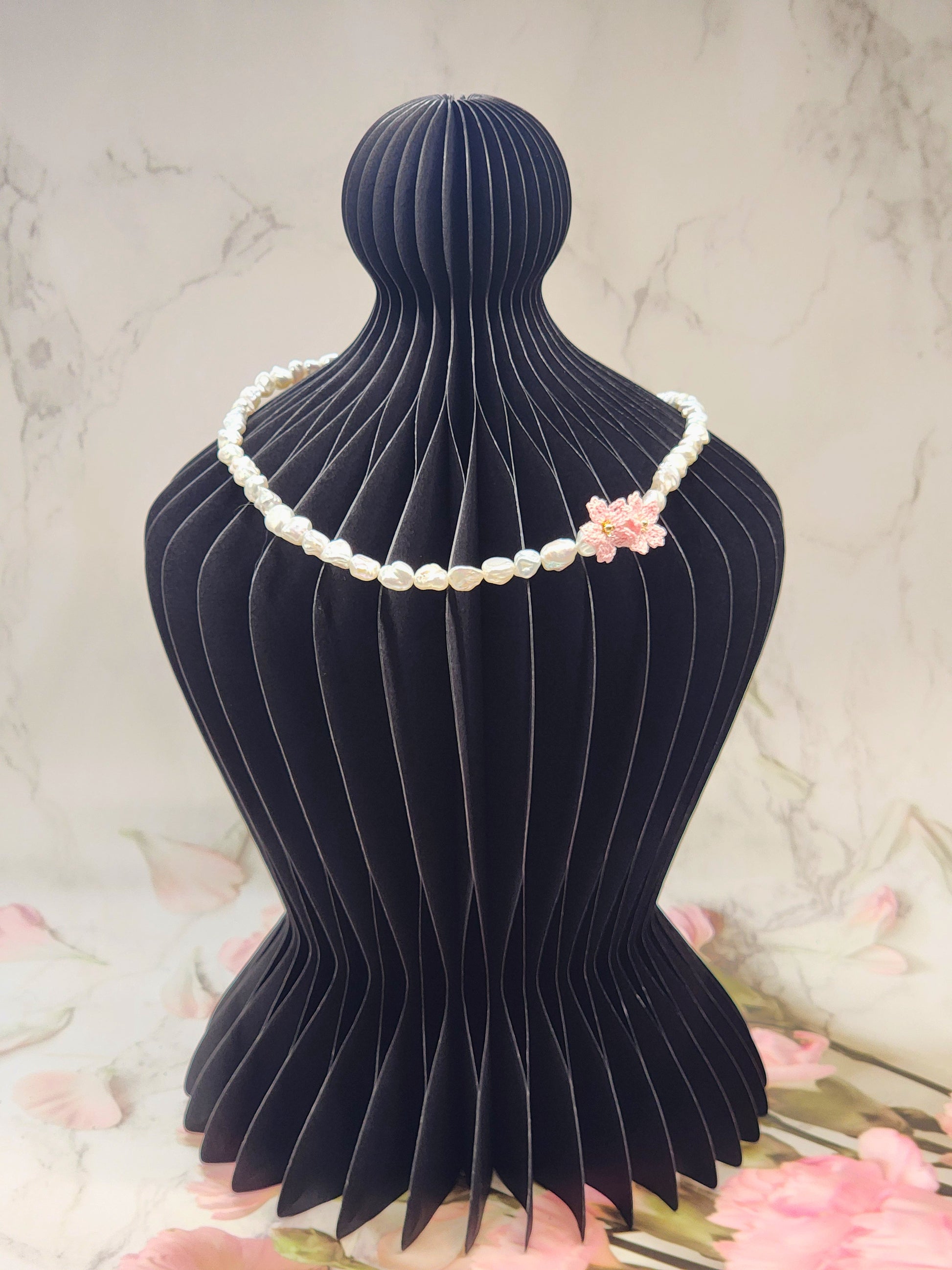 Full strand necklace. 6–7mm Keshi pearls, each one uniquely shaped and glowing with exceptional lustre. Accented with delicate micro crochet Sakura blossoms. 