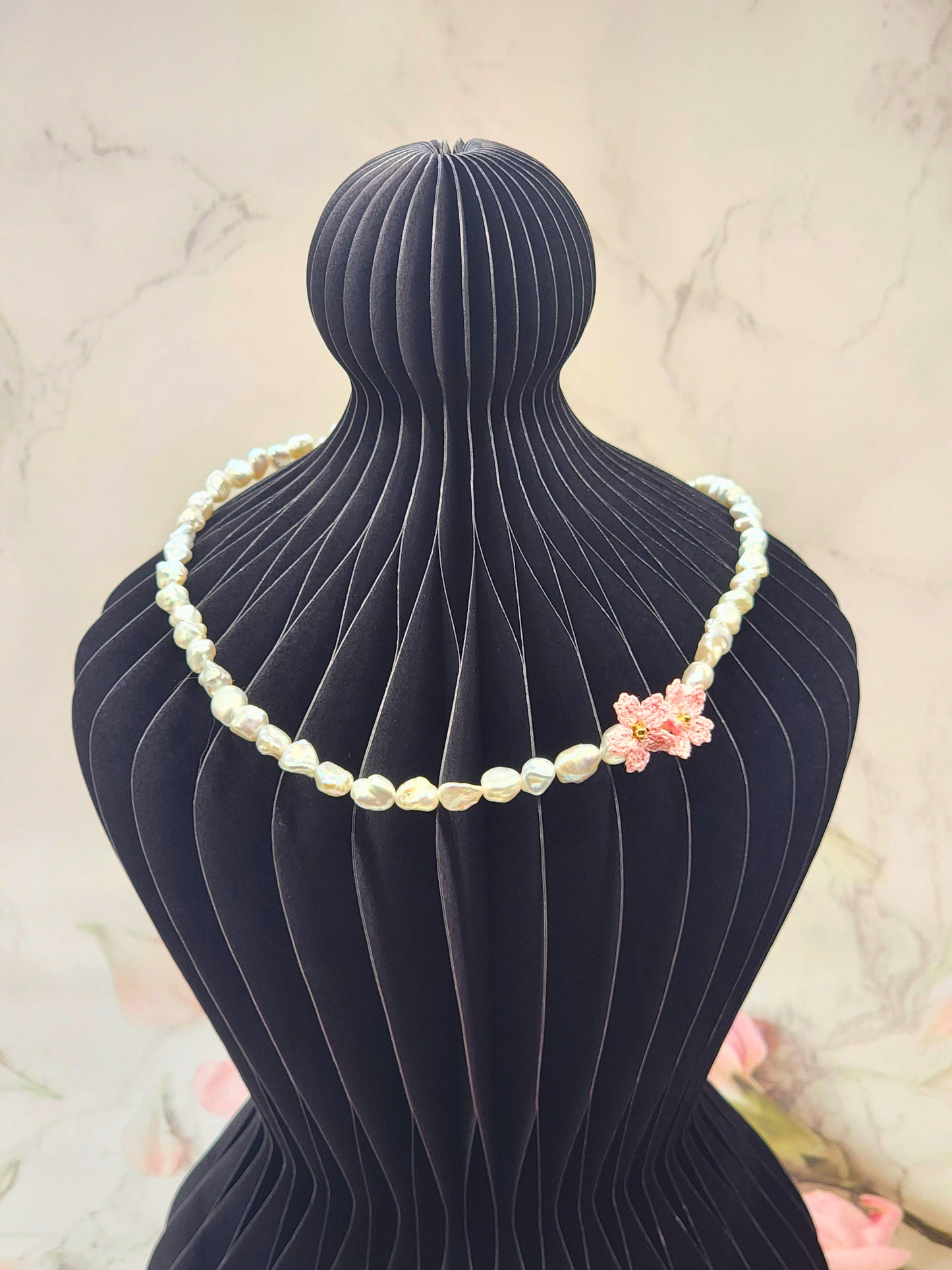 Full strand necklace. 6–7mm Keshi pearls, each one uniquely shaped and glowing with exceptional lustre. Accented with delicate micro crochet Sakura blossoms. 