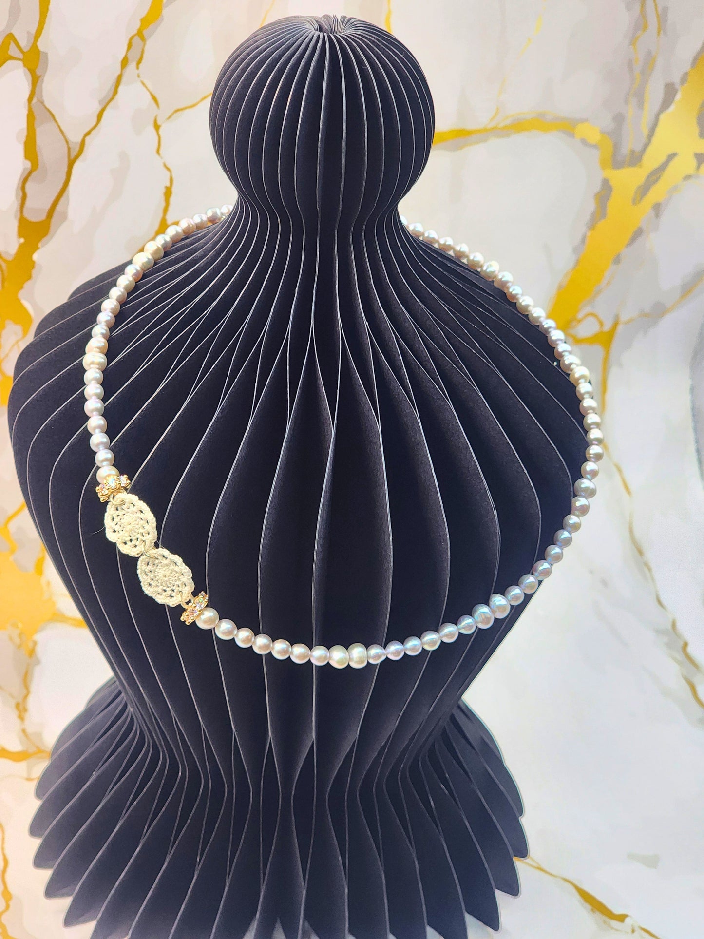 Handcrafted lace motifs paired with luminous 4-6mm silver-grey baroque pearls necklace. Accented with gold-plated cubic zirconia beads and S925 clasp.