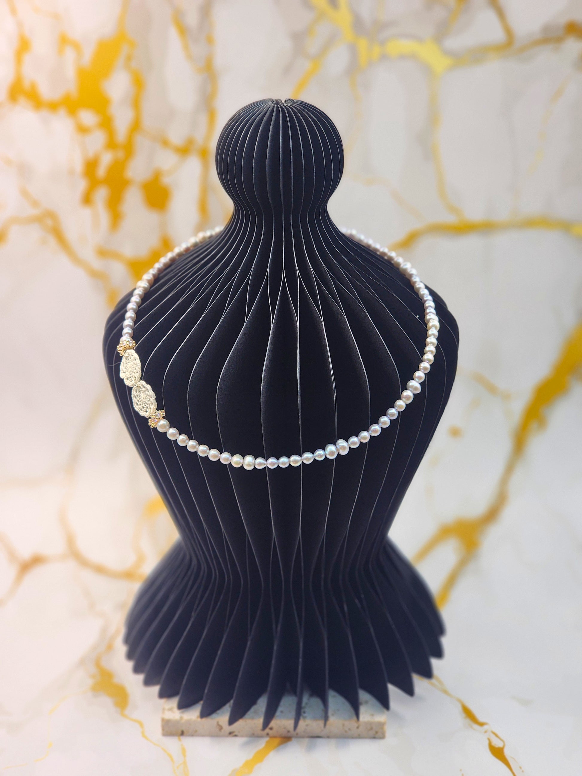Handcrafted lace motifs paired with luminous 4-6mm silver-grey baroque pearls necklace. Accented with gold-plated cubic zirconia beads and S925 clasp.