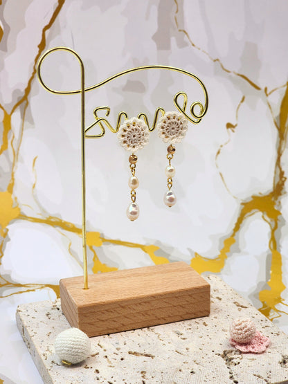 Handcrafted micro crochet lace motif, paired with double teardrop-shaped pearls. Styled with 18K gold-plated findings and studs.