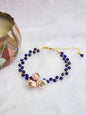 Natural Lapis Lazuli crystal bracelet with a cluster of micro-crochet snowdrops. On 14K gold-plated bangle with extension chain. 