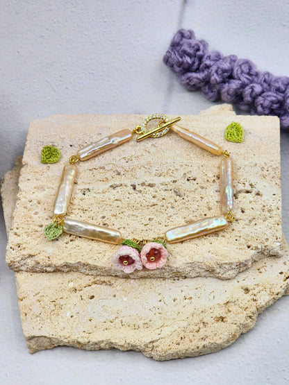 Handcrafted micro crochet Lily of the Valley blooms paired with pink-gold metallic Pipa pearls bracelet
