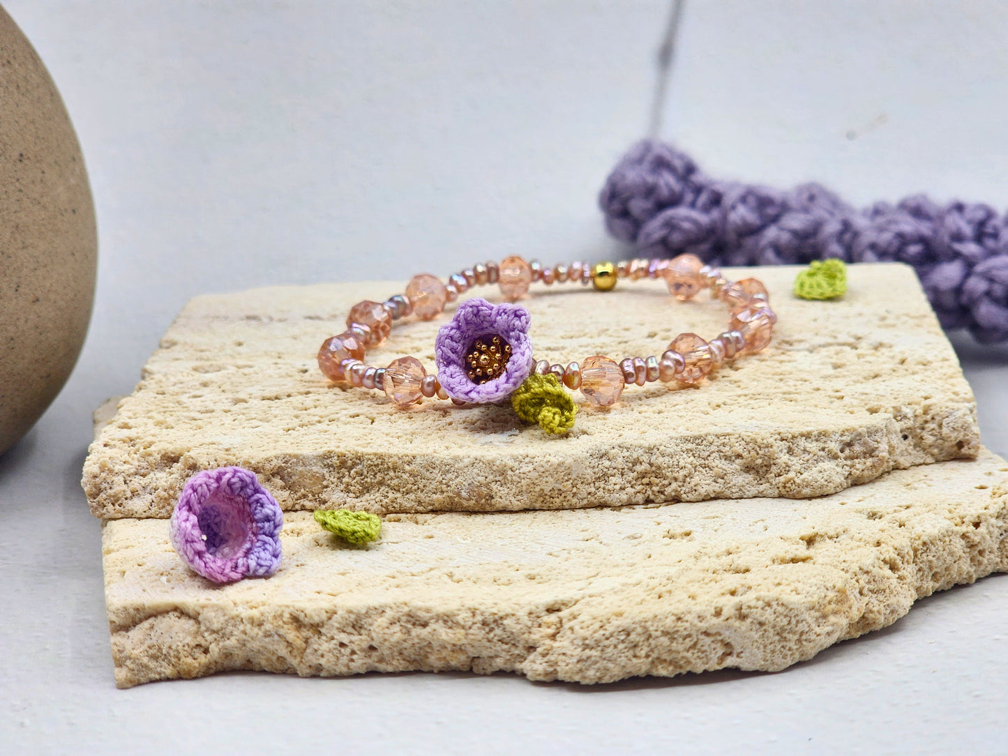 Handcrafted micro crochet Lily of the Valley bloom bracelet beautifully complemented by radiant 3–4mm metallic baroque pearls and sparkling Czech crystals.