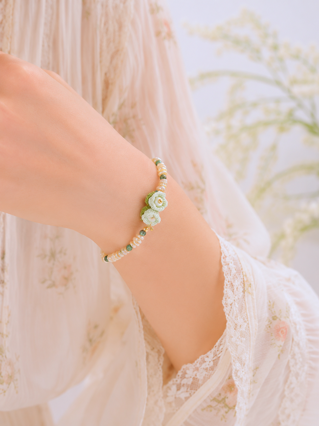 Handcrafted micro crochet Lily of the Valley blooms paired with radiant 4–5mm freshwater Keshi pearls bracelet. Natural Phoenix stones accents.
