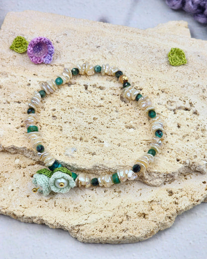 Handcrafted micro crochet Lily of the Valley blooms paired with radiant 4–5mm freshwater Keshi pearls bracelet. Natural Phoenix stones accents.