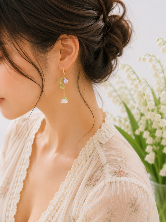 Handcrafted white micro crochet Lily of the Valley blooms accented with striking 8mm 5A-grade metallic freshwater Baroque pearls. Lilies crowned with luminous 5–6mm freshwater Aurora pearls. Gold vermeil. 