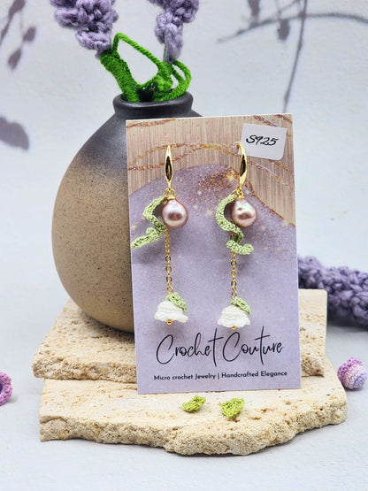 Handcrafted white micro crochet Lily of the Valley blooms accented with striking 8mm 5A-grade metallic freshwater Baroque pearls. Lilies crowned with luminous 5–6mm freshwater Aurora pearls. Gold vermeil. 
