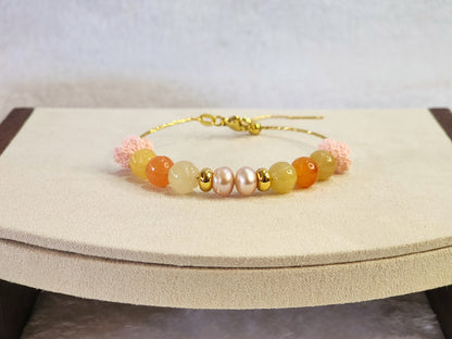 Natural quartz crystals and pearls bracelet with pink handcrafted micro-crochet peach blossoms on 18K gold-plated bracelet.