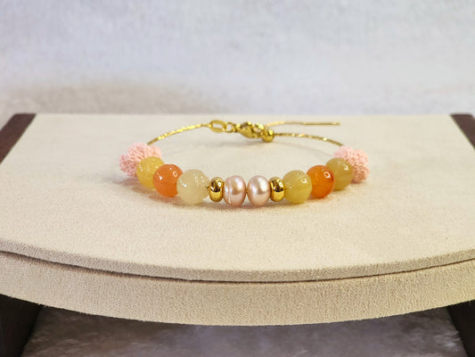 Natural quartz crystals and pearls bracelet with pink handcrafted micro-crochet peach blossoms on 18K gold-plated bracelet.