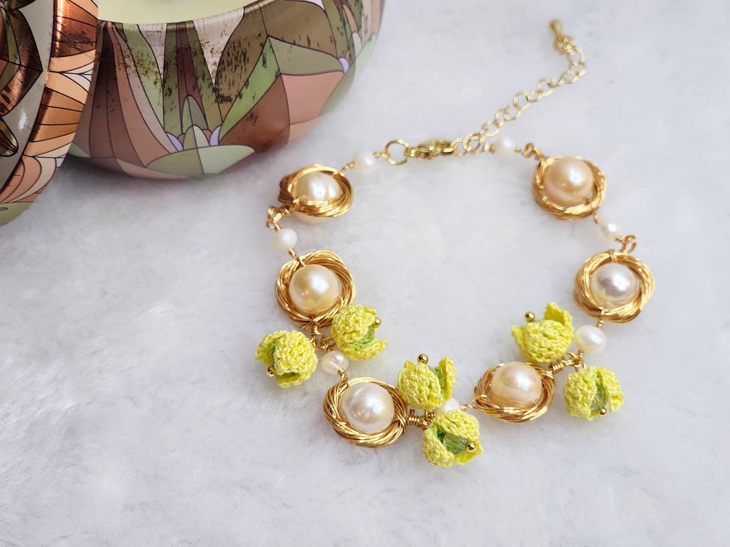 Near round 8-9mm pearls bracelet adorned with micro-crochet snowdrops on 18K gold-plated chain.