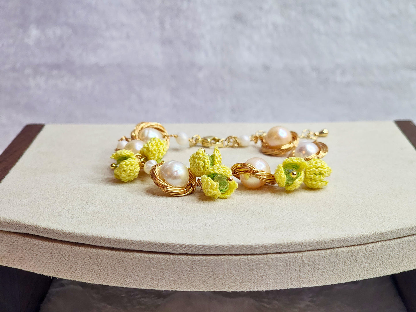 Near round 8-9mm pearls bracelet adorned with micro-crochet snowdrops on 18K gold-plated chain.