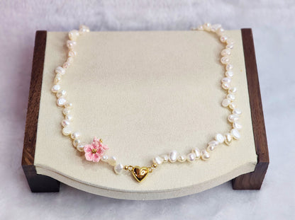 Natural Baroque pearl choker with gold-plated heart charm and pink micro-crochet peach blossoms.   