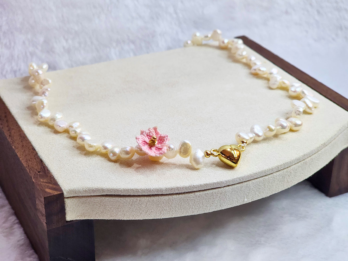 Natural Baroque pearl choker with gold-plated heart charm and pink micro-crochet peach blossoms. 