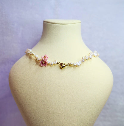 Natural Baroque pearl choker with gold-plated heart charm and pink micro-crochet peach blossoms. 