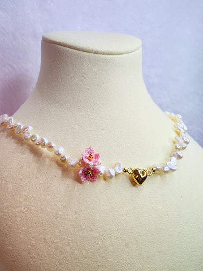 Natural Baroque pearl choker with gold-plated heart charm and pink micro-crochet peach blossoms. 