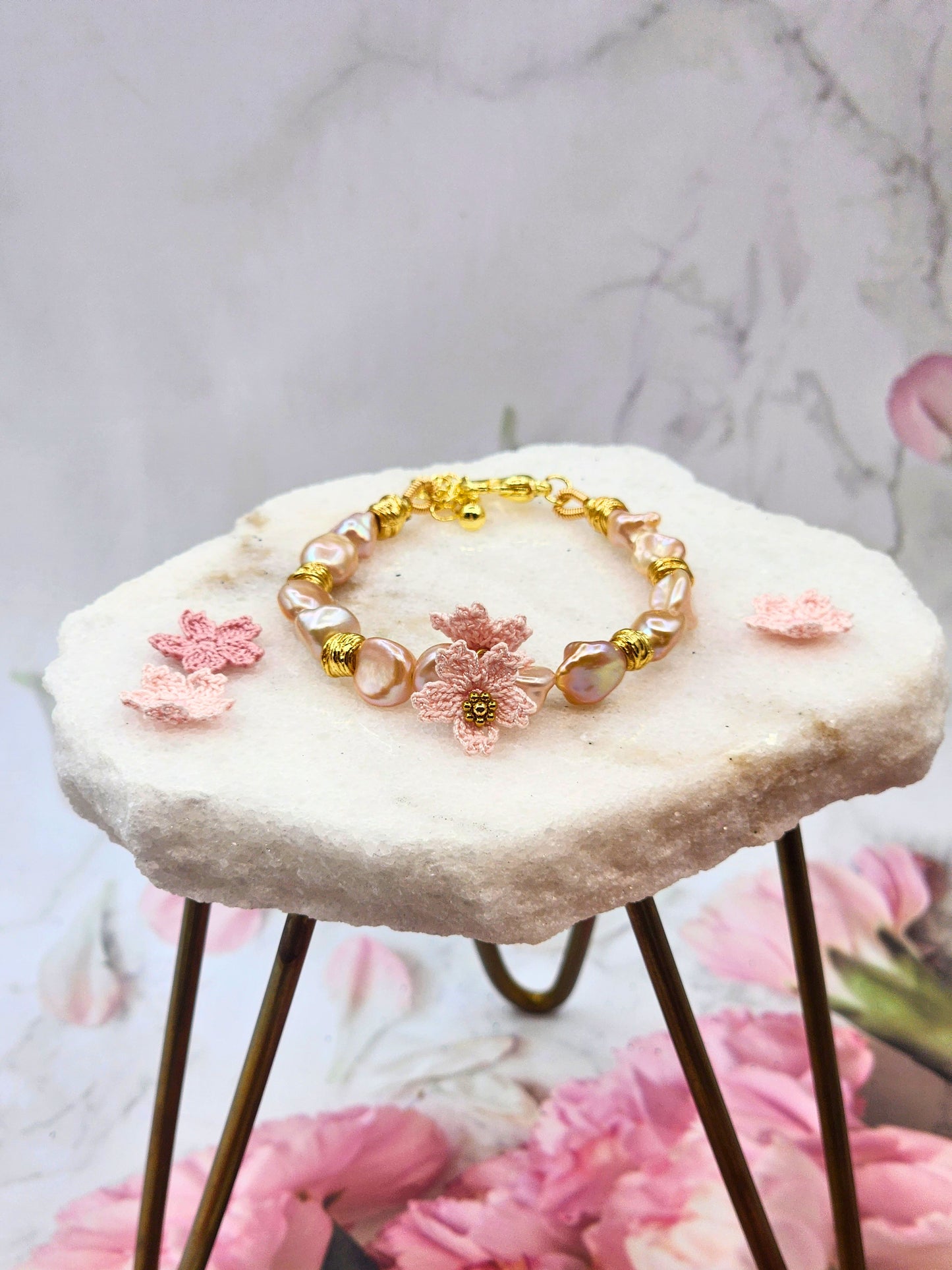 Elevate your style with rare pink-purple radiant Keshi pearls & micro crochet Sakura. 18K gold-plated jewelry wire, spacer beads, & a heart-shaped clasp.