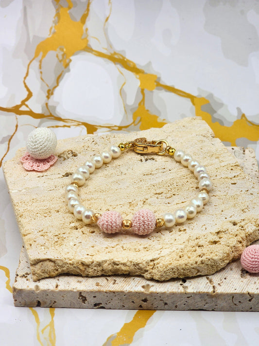 Handcrafted pink 'crochet pearls', beautifully framed by near-round 5–6mm freshwater pearls, chosen for their radiant lustre and smooth, luminous finish. 18K gold-plated accent beads and a clasp adorned with cubic zirconia. 