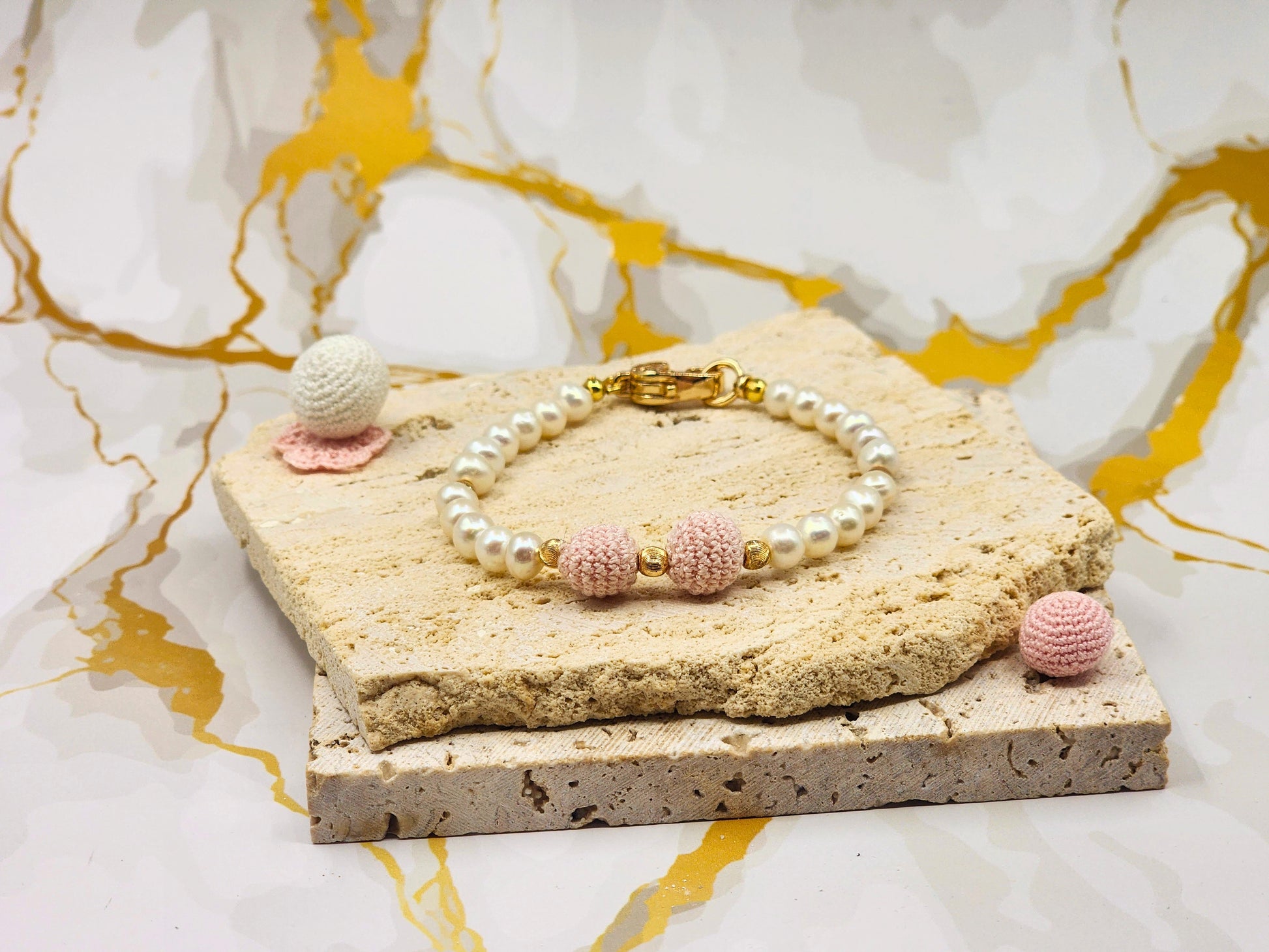 Handcrafted pink 'crochet pearls', beautifully framed by near-round 5–6mm freshwater pearls, chosen for their radiant lustre and smooth, luminous finish. 18K gold-plated accent beads and a clasp adorned with cubic zirconia.