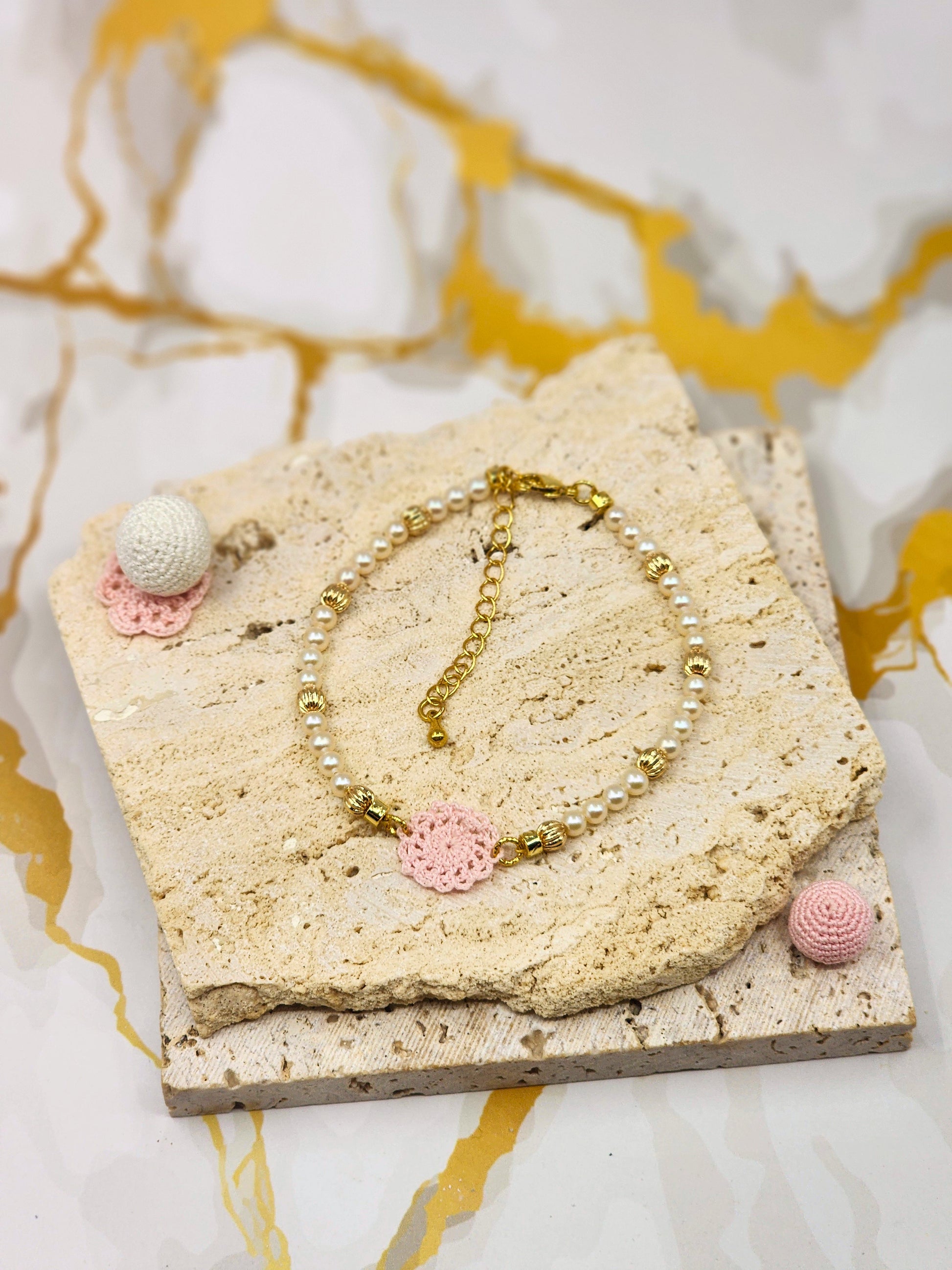 Handcrafted lace motif, beautifully framed by 4–5mm high lustre, flawless freshwater pearl. 18K gold-plated bead accents and clasp.