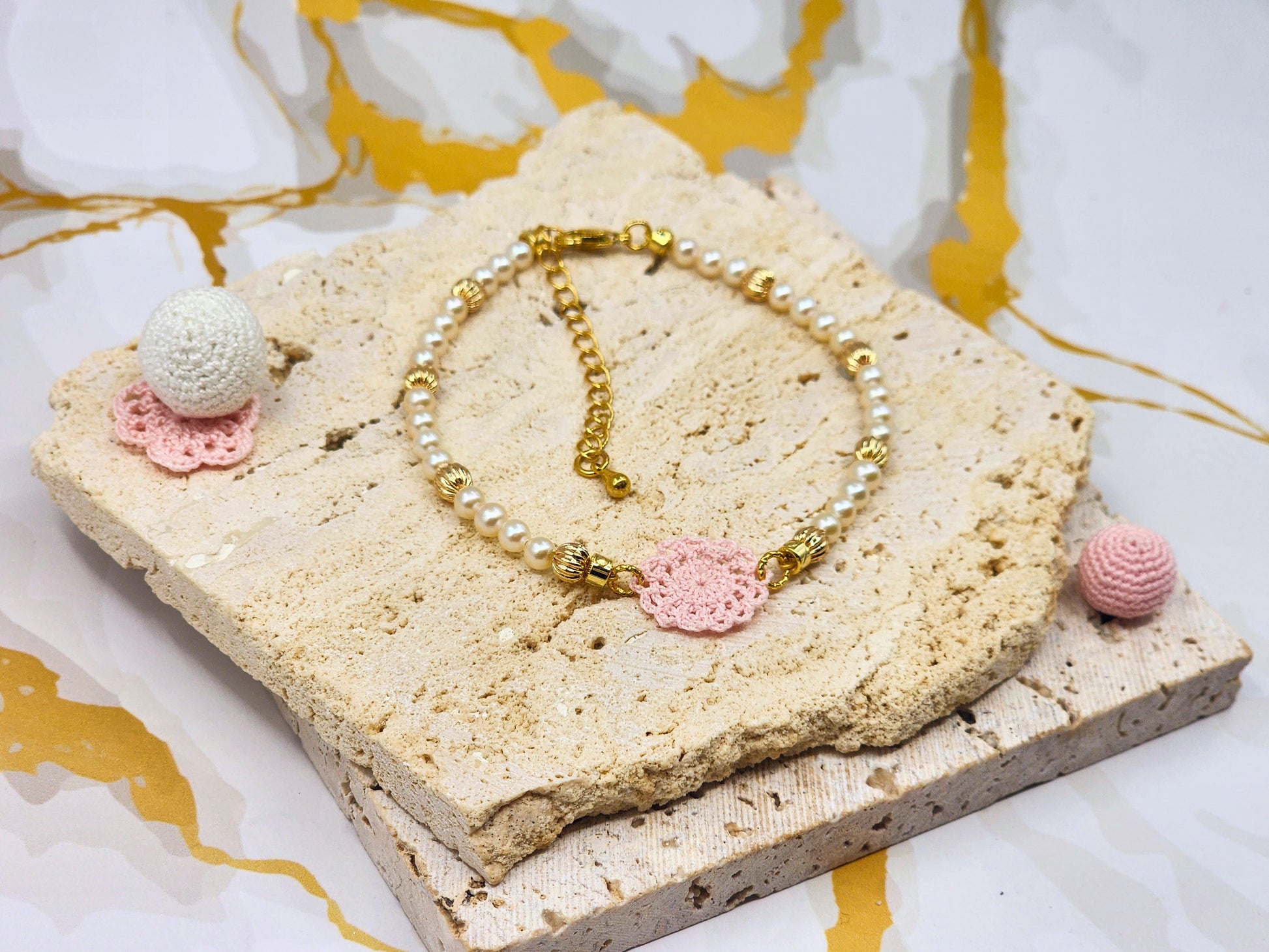 Handcrafted lace motif, beautifully framed by 4–5mm high lustre, flawless freshwater pearl. 18K gold-plated bead accents and clasp.