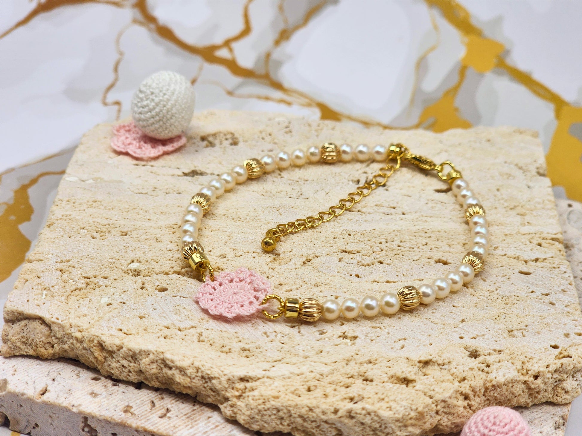 Handcrafted lace motif, beautifully framed by 4–5mm high lustre, flawless freshwater pearl. 18K gold-plated bead accents and clasp.
