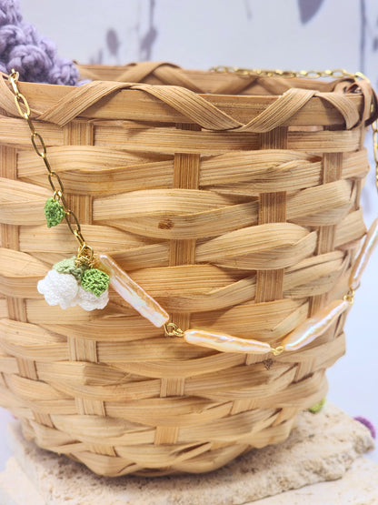 Pink-gold metallic Pipa pearls necklace with delicate micro crochet Lily of the Valley blooms crowned with 6mm Aurora pearls. 18K gold-plated titanium steel chain.
