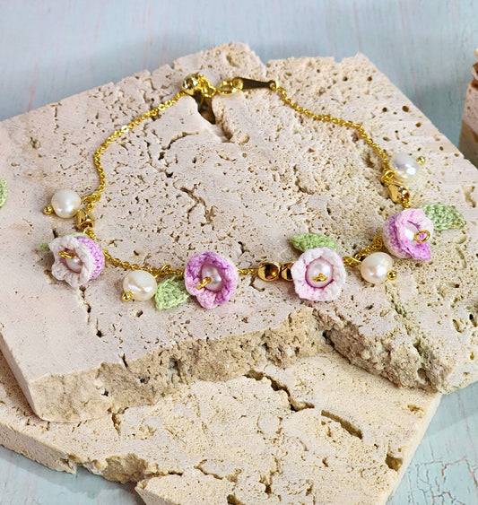 Pink-white micro‑crochet Lilies of the Valley adorned with 4.5-5mm natural Freshwater Pearls, 5-6mm natural Baroque Pearls and 18K gold-plated spacers. Gracefully set on a 18K gold-plated Y bracelet.