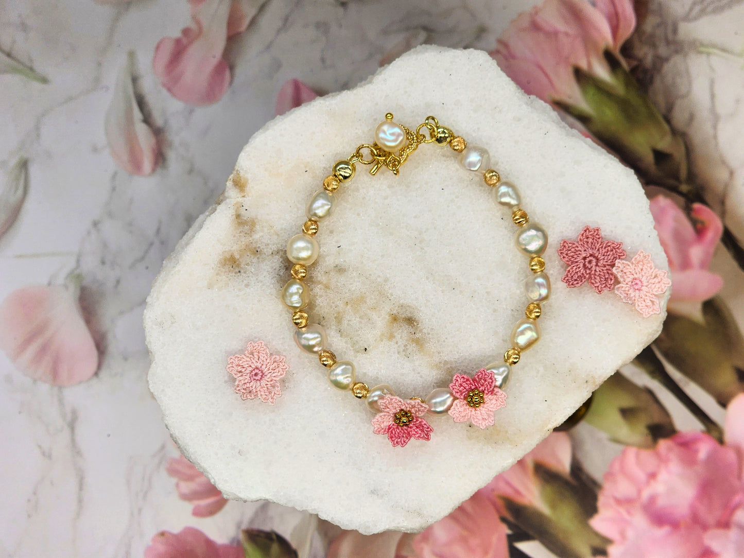 Radiant 7-8mm Keshi pearls & micro crochet Sakura blossoms bracelet. 18K gold-plated jewelry wire, bold spacer beads, and chain clasp.
