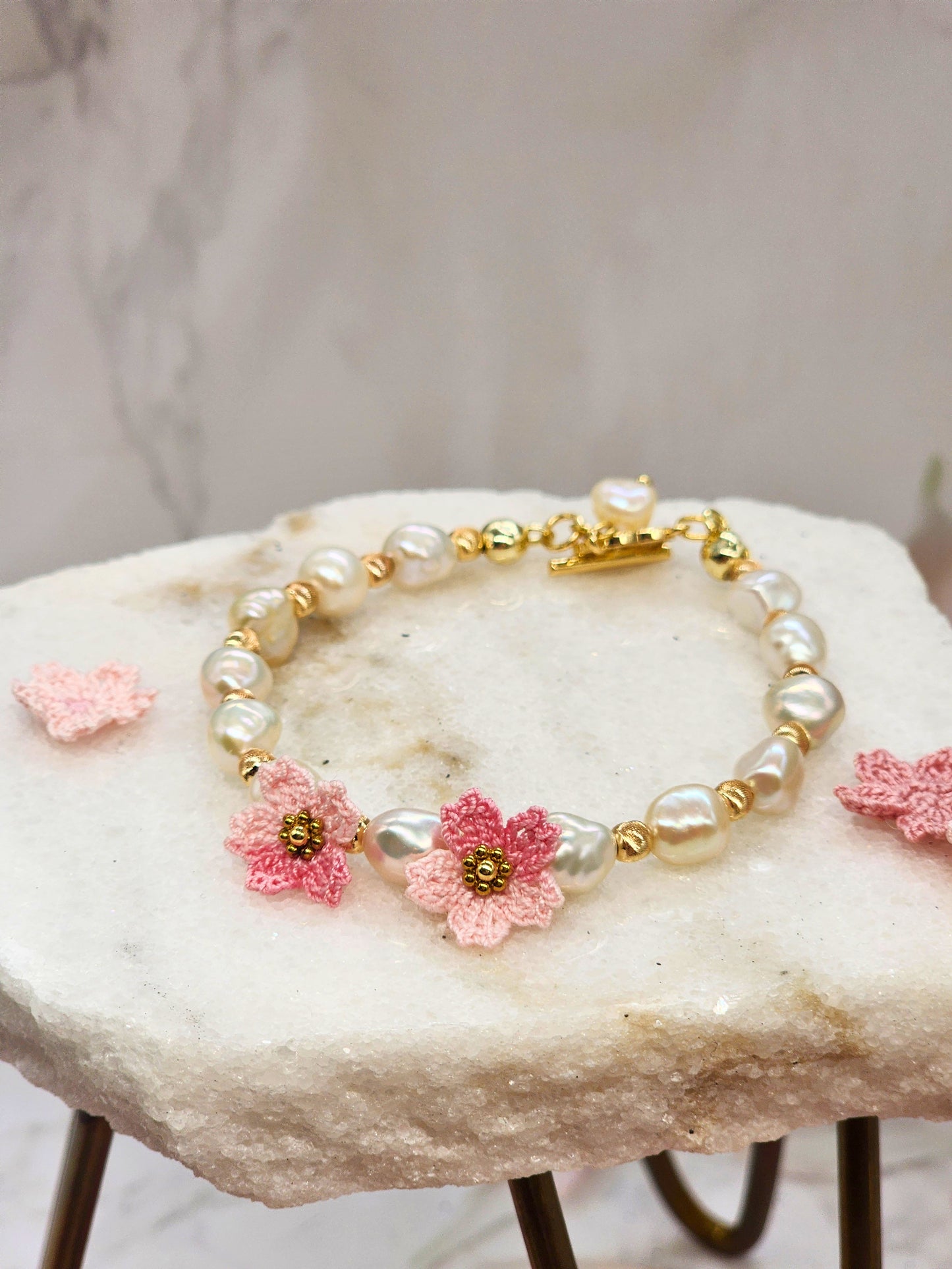 Radiant 7-8mm Keshi pearls & micro crochet Sakura blossoms bracelet. 18K gold-plated jewelry wire, bold spacer beads, and chain clasp.