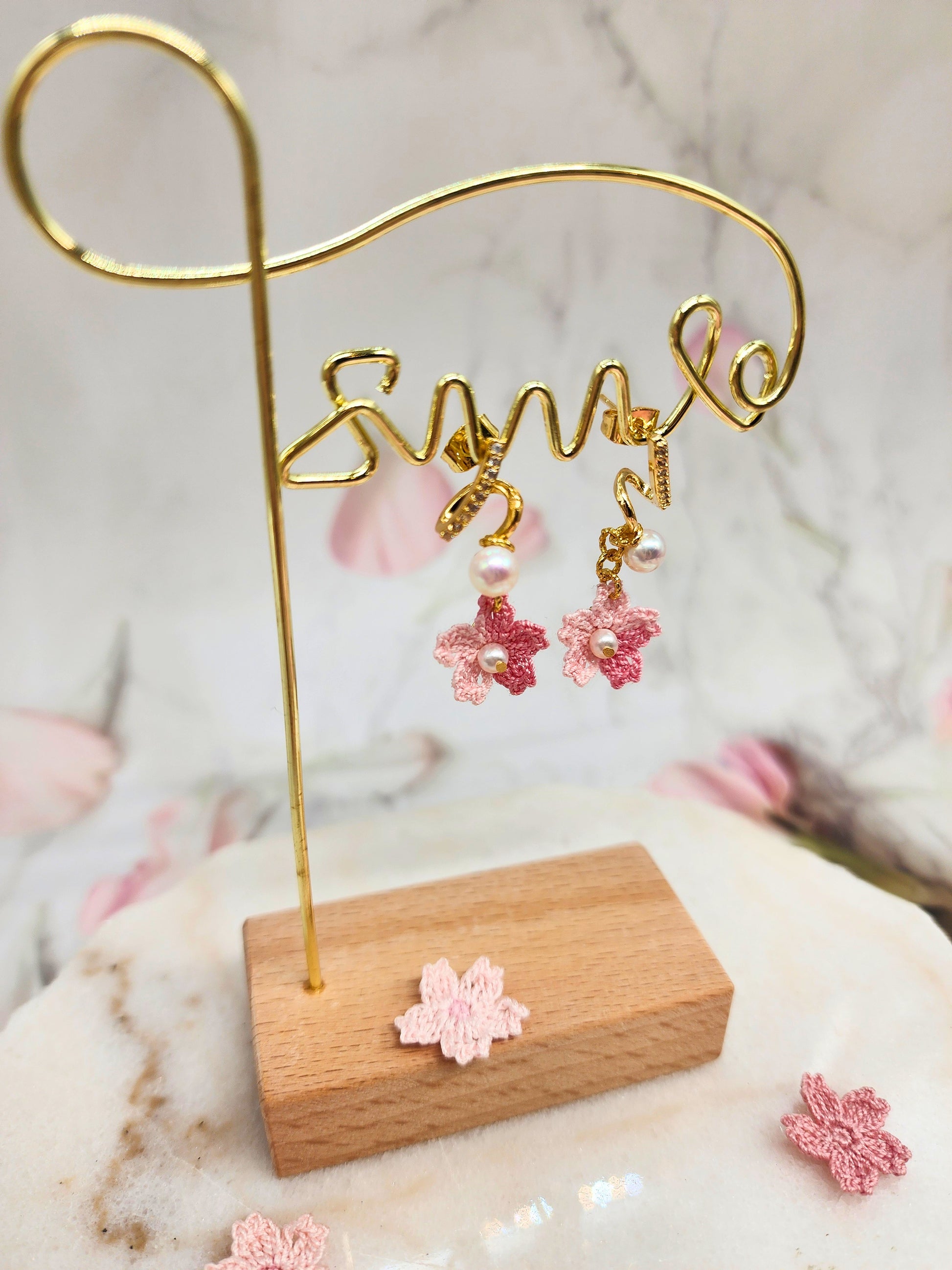 Aurora pearls and sparkling cubic zirconia meet micro crochet Sakura blossoms. 18K gold-plated.