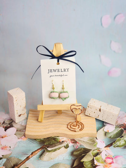 A pair of sweet Sakura mochi micro-crochet earrings handcrafted with ultra-fine lace yarn and 18K gold-plated hooks
