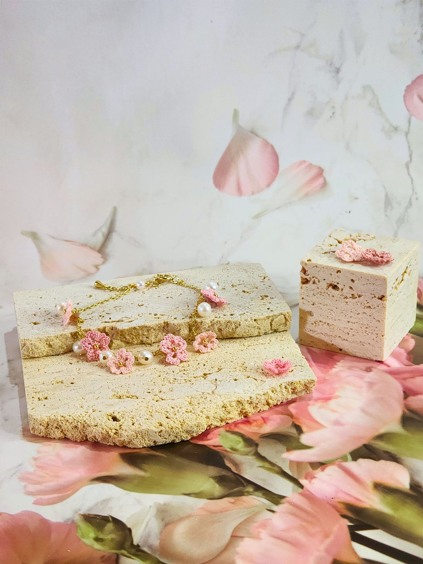 Handcrafted micro-crochet Sakura blossoms flanked by natural 5-6mm freshwater pearls on an 14K gold-plated bracelet. 