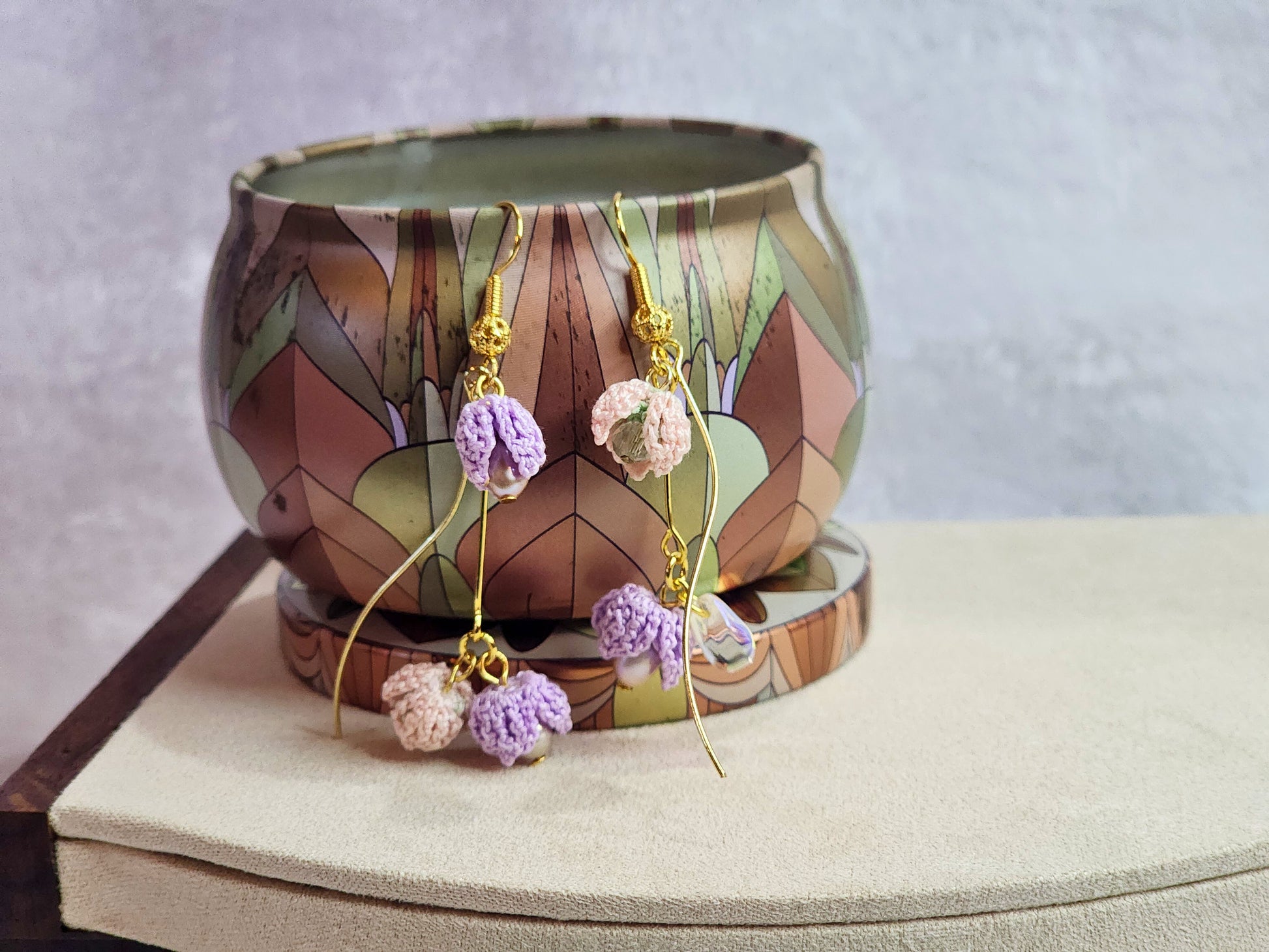 Handcrafted trio of pink & purple micro-crochet snowdrops and 4-5mm purple rice pearls with a mix of premium crystals and glass beads.  18K gold-plated findings and hooks. 