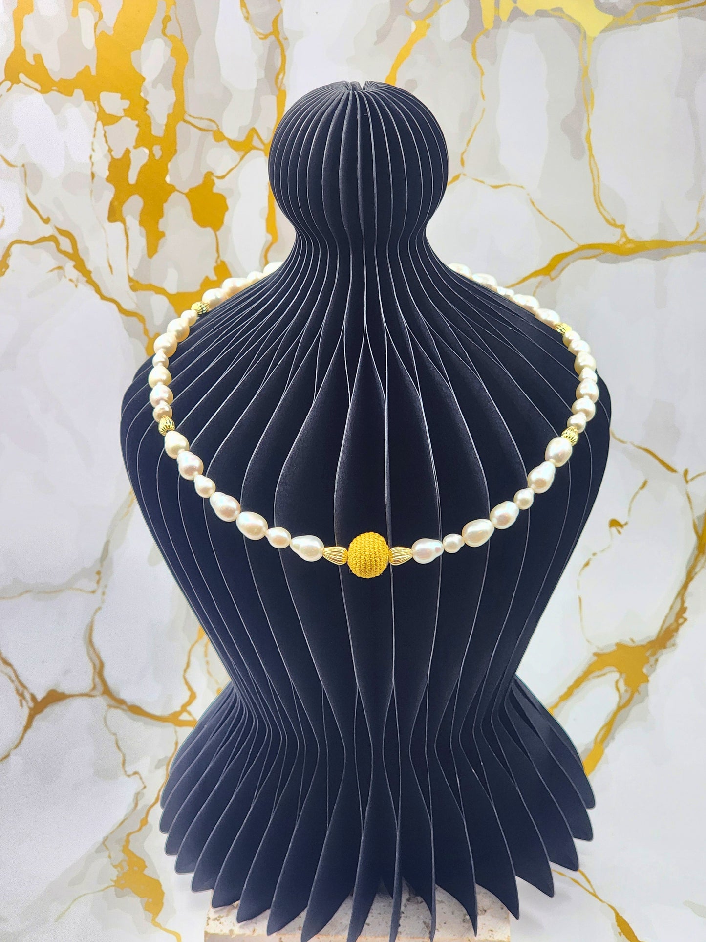 Handcrafted gold crochet pearl beautifully framed by 7–9mm high-lustre, near-flawless teardrop pearls.  Complemented by 18K gold-plated accent beads and an elegant clasp.