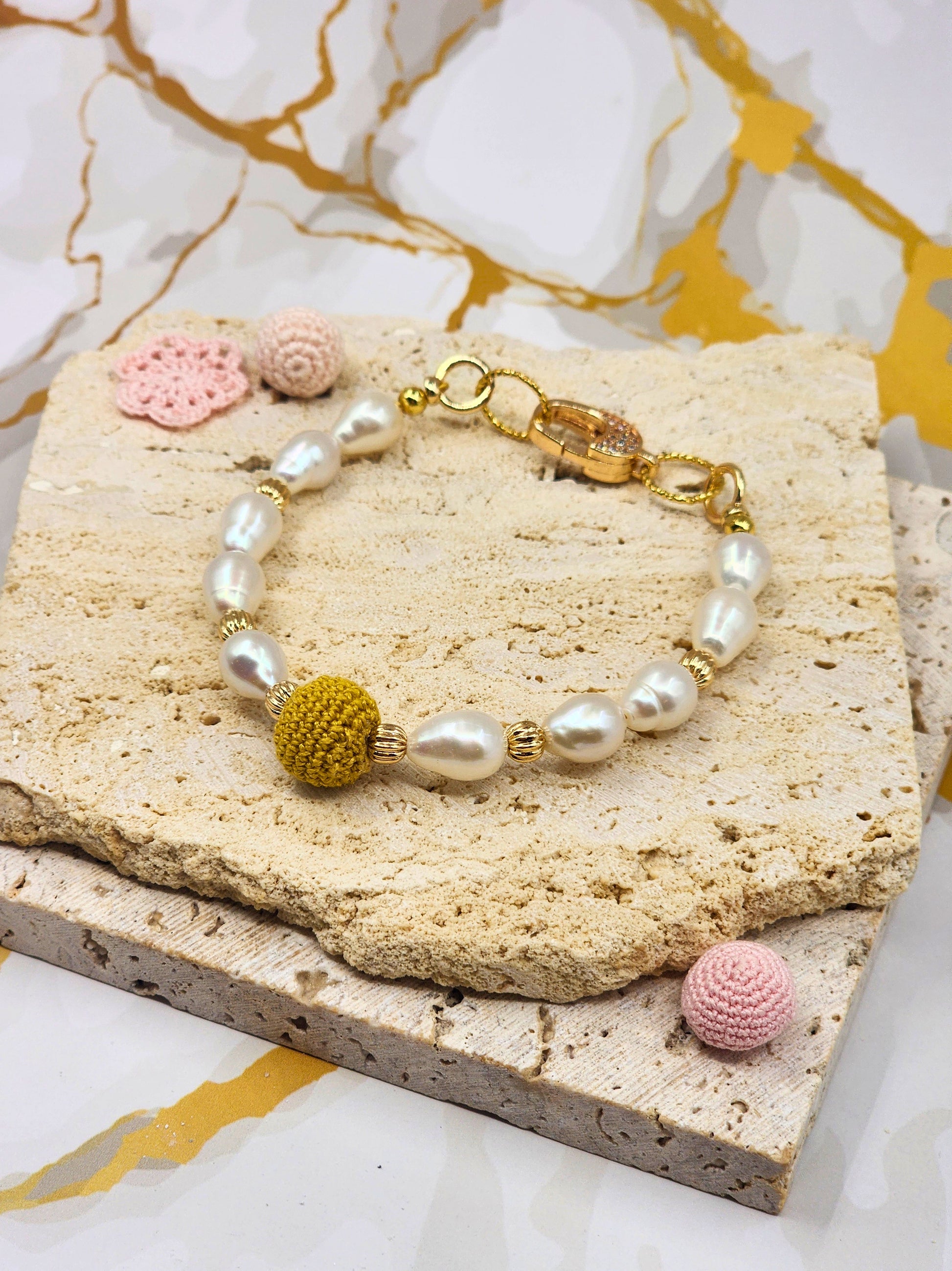 Handcrafted “South Sea Gold Crochet Pearl” beautifully framed by 7–8mm high lustre, flawless teardrop-shaped pearls. Styled with 18K gold-plated bead accents and a clasp with sparkling cubic zirconia.