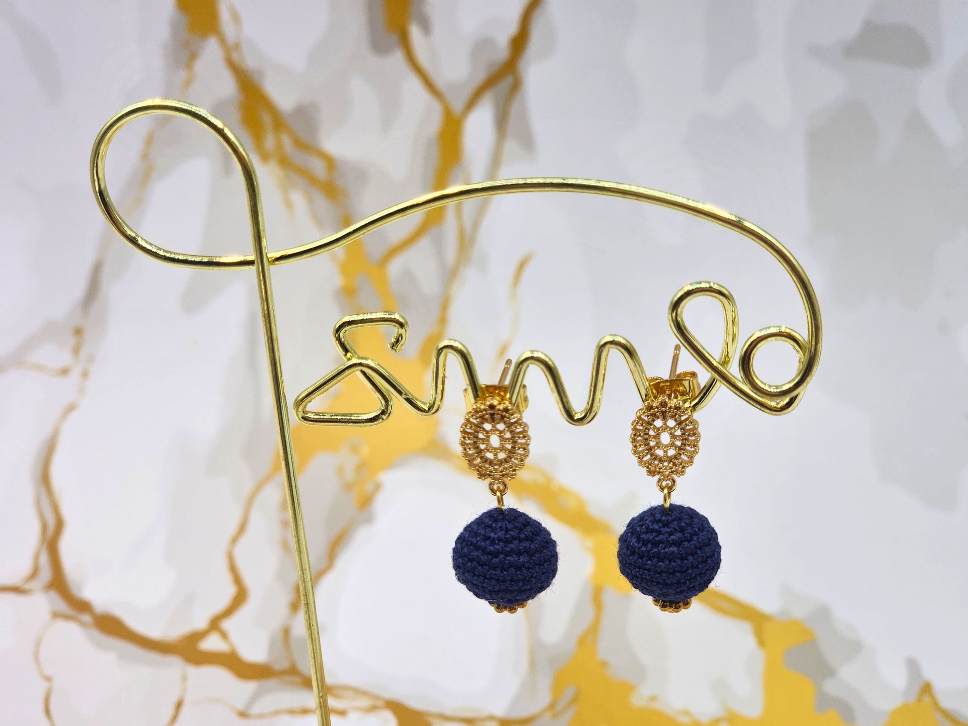Handcrafted deep blue crochet pearls inspired by the mysterious beauty of Tahitian pearls. Finished with 18K gold-plated lace studs.