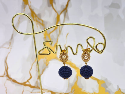 Handcrafted deep blue crochet pearls inspired by the mysterious beauty of Tahitian pearls. Finished with 18K gold-plated lace studs.