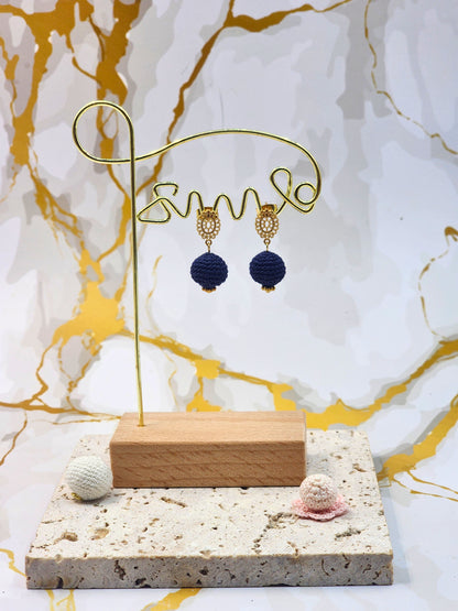 Handcrafted deep blue crochet pearls inspired by the mysterious beauty of Tahitian pearls. Finished with 18K gold-plated lace studs.