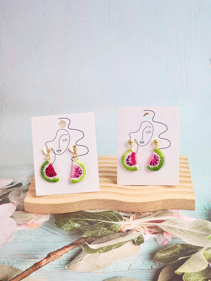 A pair of watermelon slice micro-crochet earrings handcrafted with ultra-fine lace yarn and 18K gold-plated studs