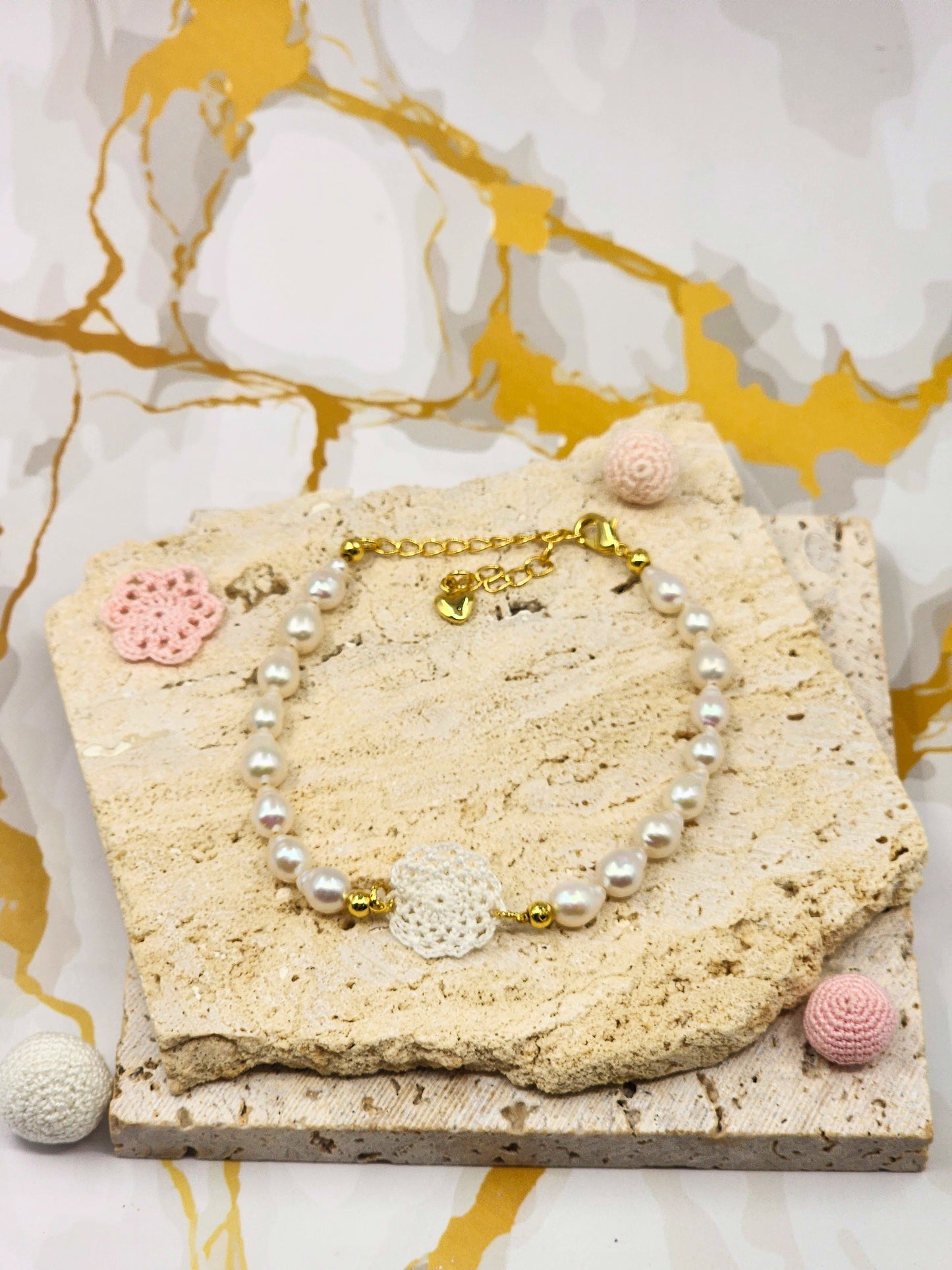 Handcrafted lace motif, beautifully framed by flawless 7–8mm teardrop-shaped pearls bracelet. Styled with 18K gold-plated bead accents and clasp.