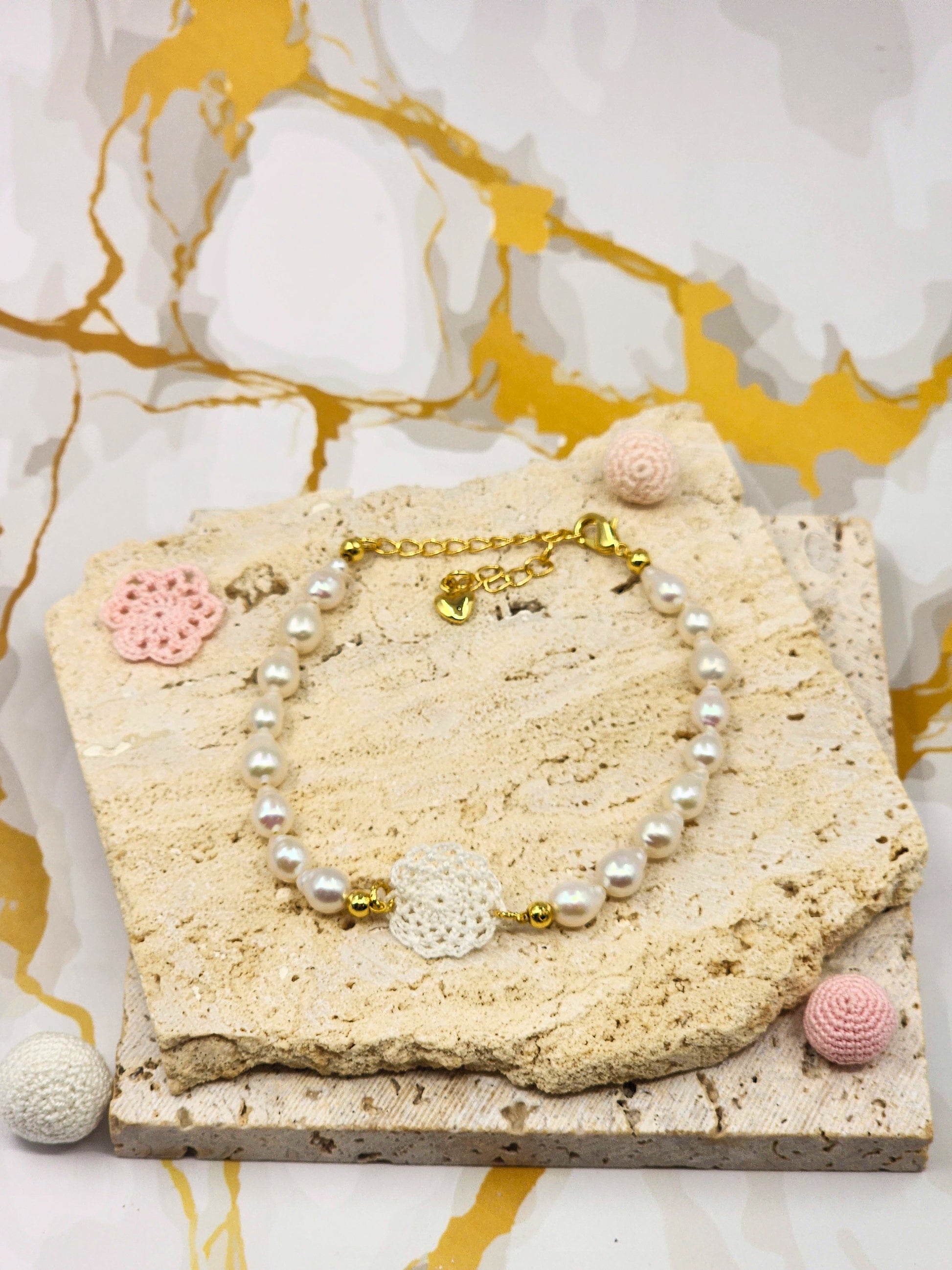 Handcrafted lace motif, beautifully framed by flawless 7–8mm teardrop-shaped pearls bracelet. Styled with 18K gold-plated bead accents and clasp.